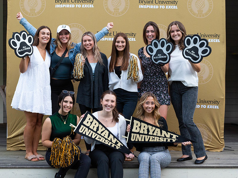 Bryant students hold up Bryant gear