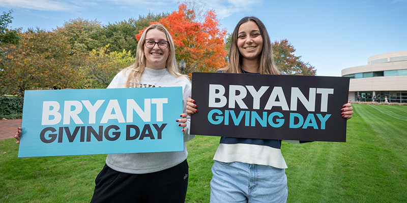 Students holding Bryant Giving Day signs